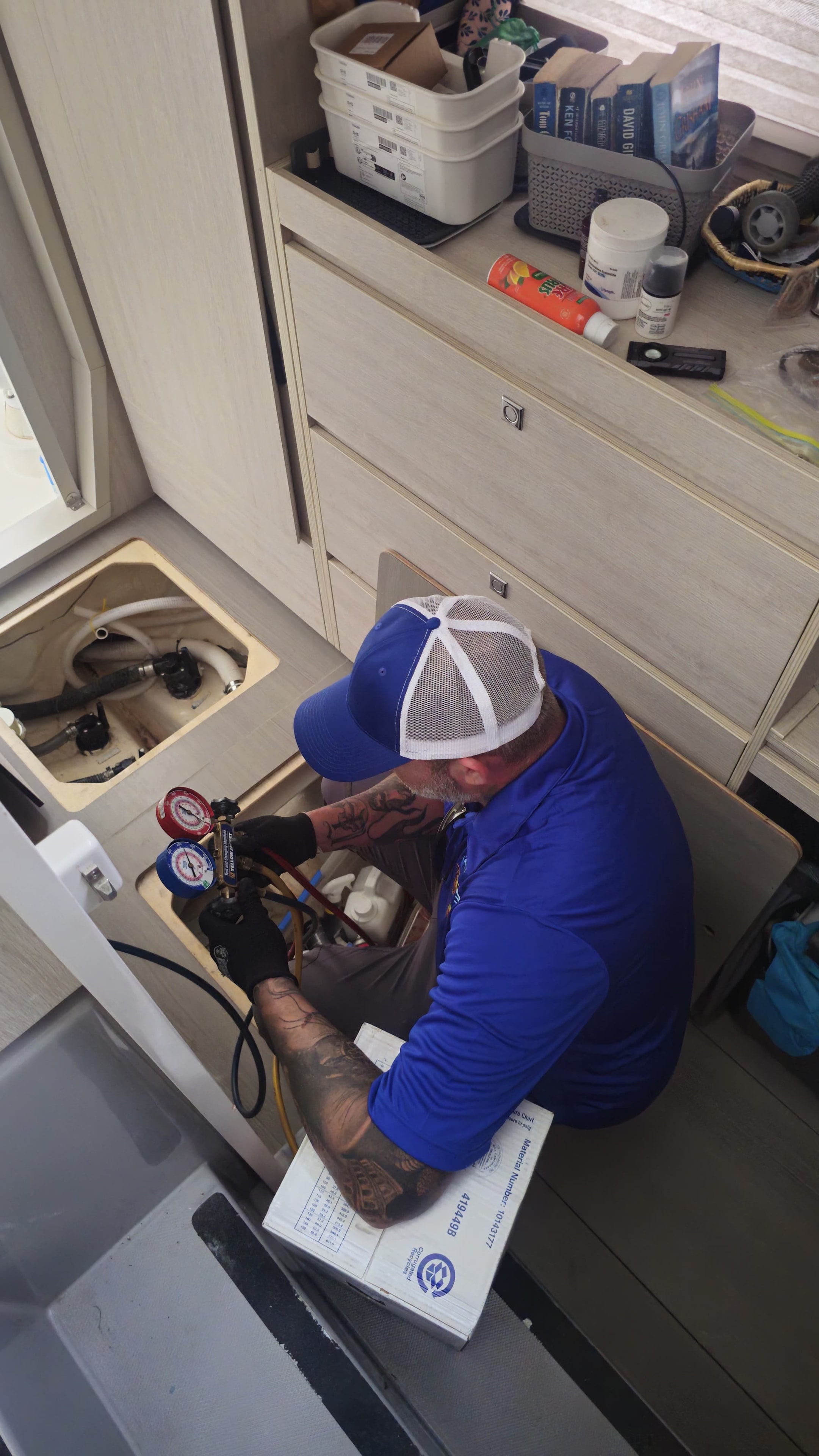 Marine technician diagnosing boat HVAC system